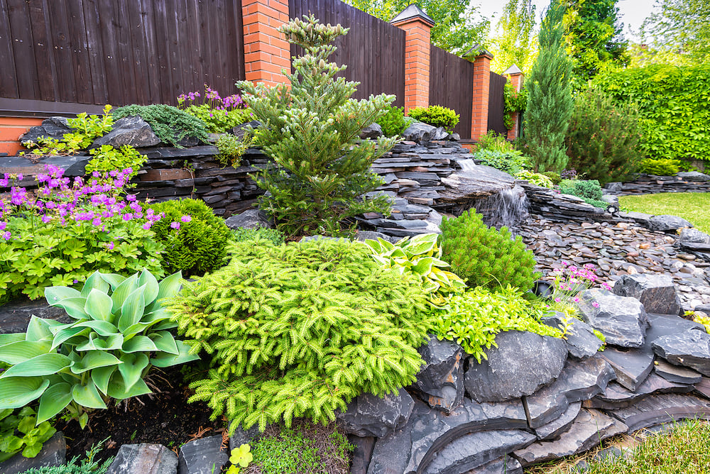 small yards garden bed and stone wall